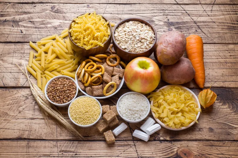 foods high in carbohydrate on rustic wooden background