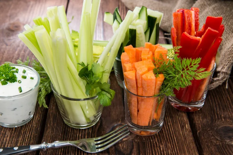 fresh vegetables in clear glasses and white dip