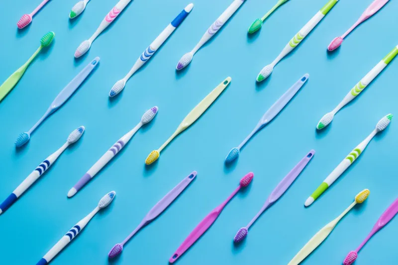 top view of toothbrushes in colorful on pastel color background