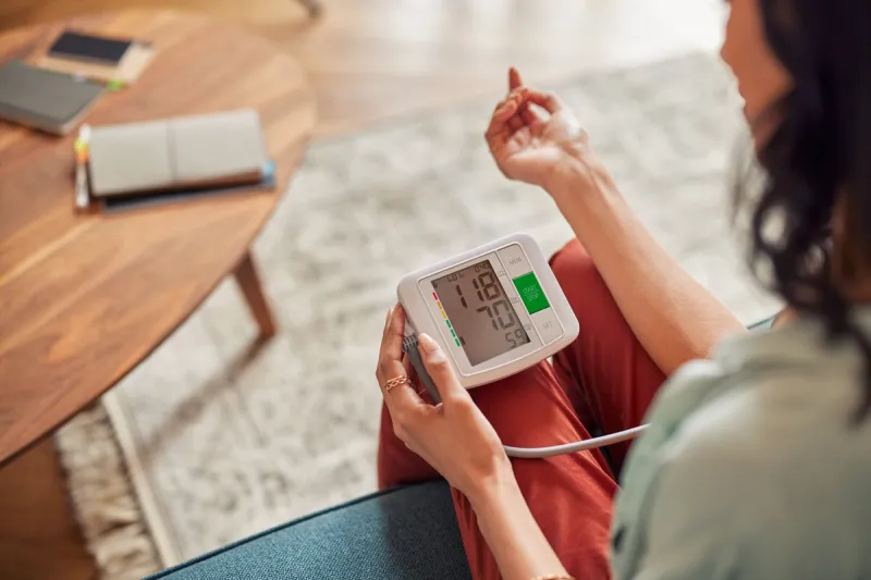 close up of young woman checking blood pressure