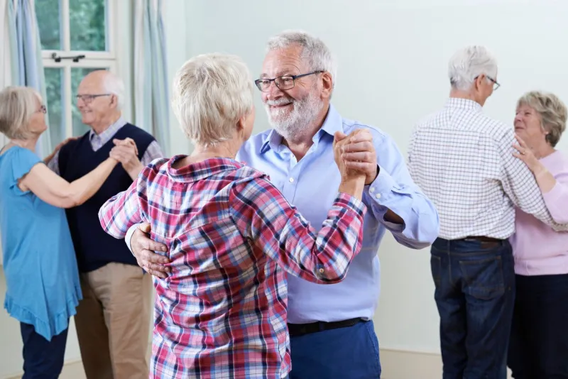 group of seniors enjoying dancing club together