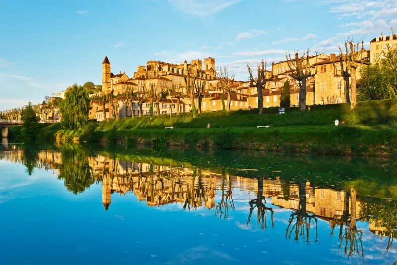 ancient auch cityscape with armagnac tower and saint marie cathedral, reflecting in gers river, its historical capital of gascony, france, midi pyrenees