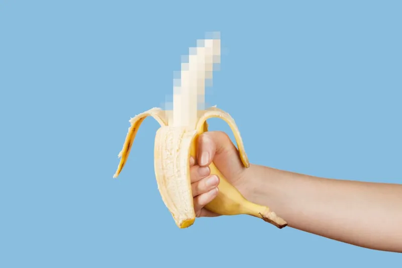 hidden censored banana in hand on a blue background horny (aroused) penis, male erection and sexual education funny pornography