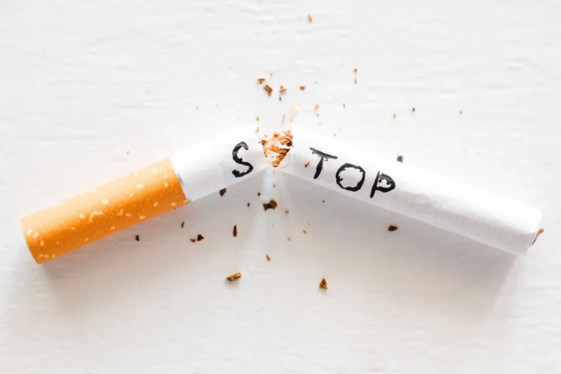 broken cigarette with the word stop stop smoking concept closeup