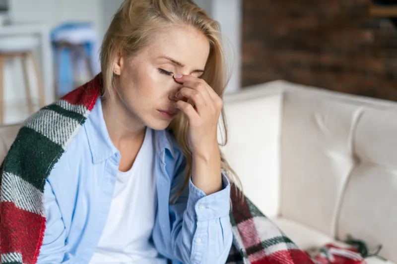 fatigue and upset woman touching nose bridge feeling eye strain or headache, trying to relieve pain sick and exhausted female spending day at home depressed lady feeling weary dizzy