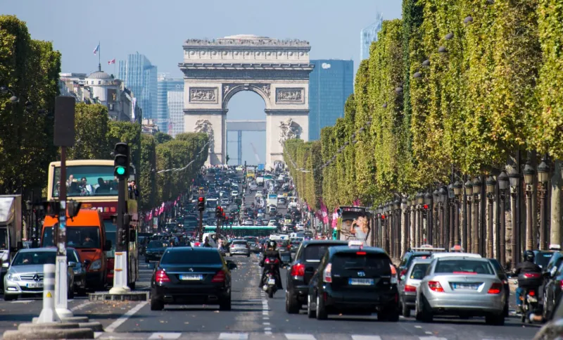 paris, france - september 13, 2014  traffic at avenue des champs-Élysées with arc de triomphe and skyscrapers
