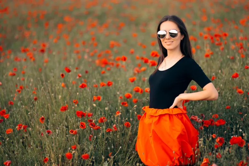 trendy female mode in fashionable outfit standing outdoors