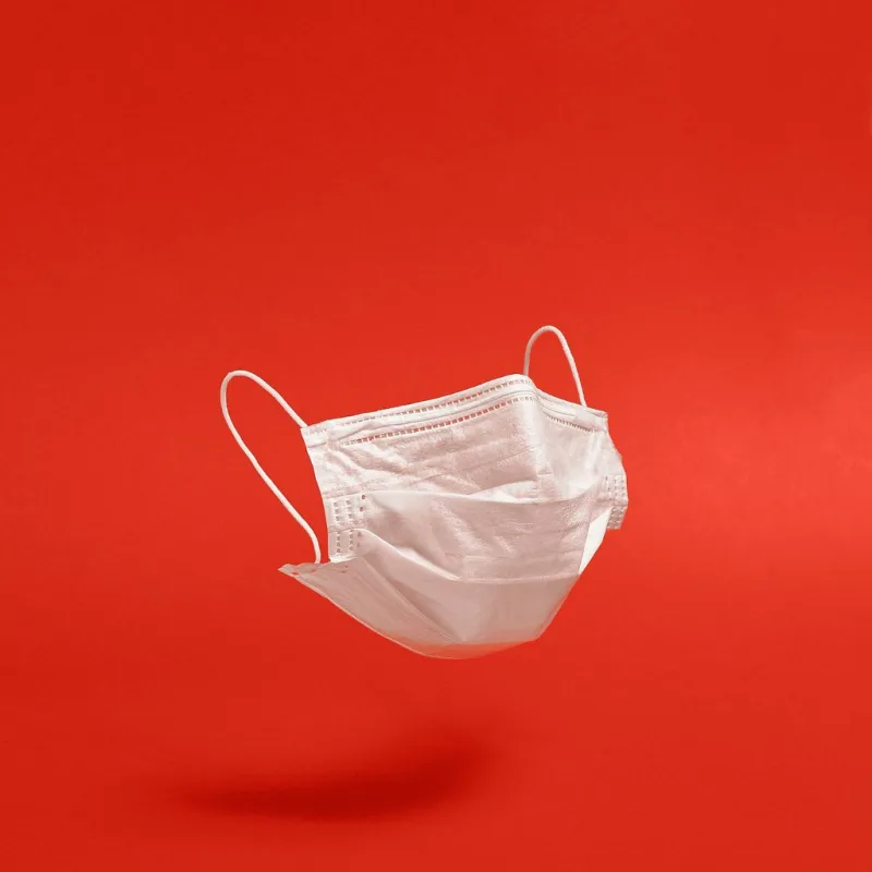 surgical face mask on red background minimal medical concept medical equipment