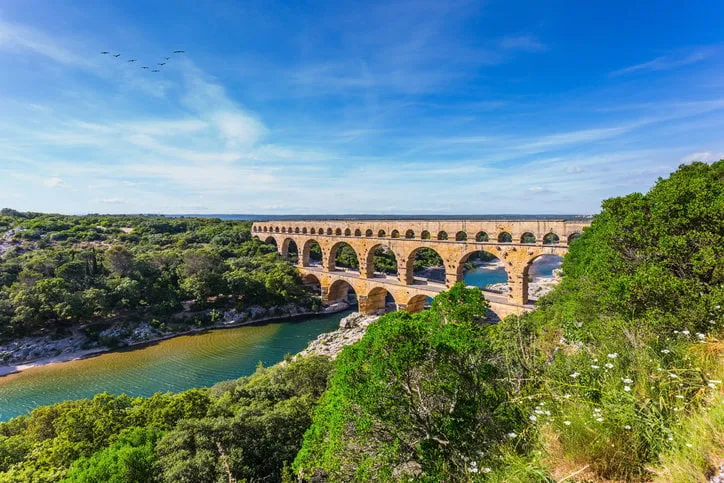 three-tiered aqueduct pont du gard was built in roman times on the river gardon around the bridge is magnificent natural park provence, spring sunny day