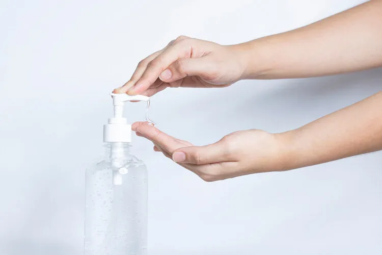female using hand sanitizer gel clean protect virus bacteria covid-19 contagious disease