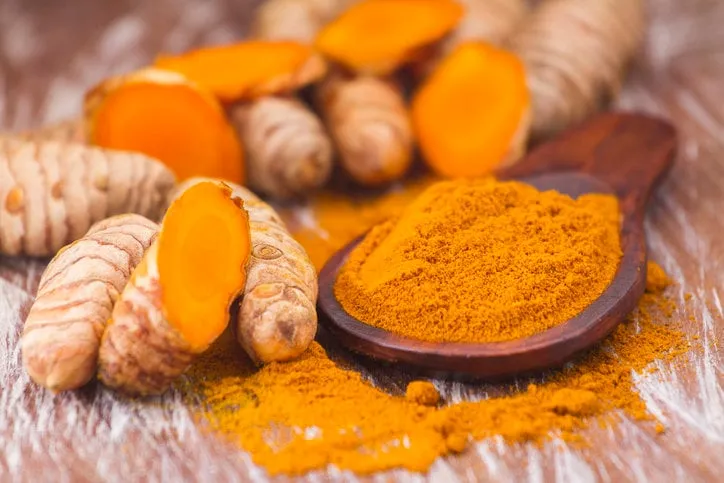 turmeric powder and roots, asian origin plant containing curcumin has very powerful anti-inflammatory and antioxidant properties