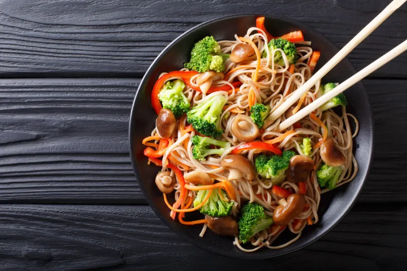 fried soba noodles with mushrooms, broccoli, carrots, peppers cl