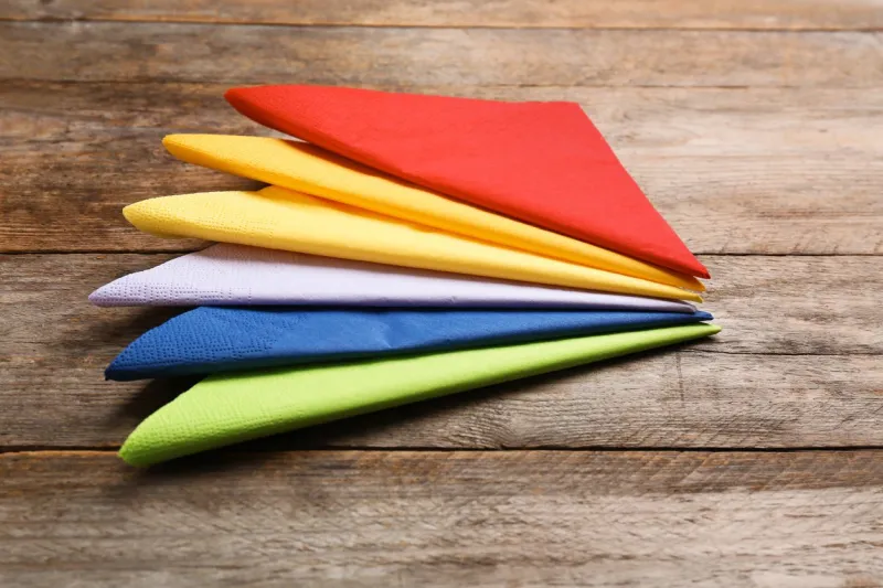 colorful paper napkins on wooden background personal hygiene