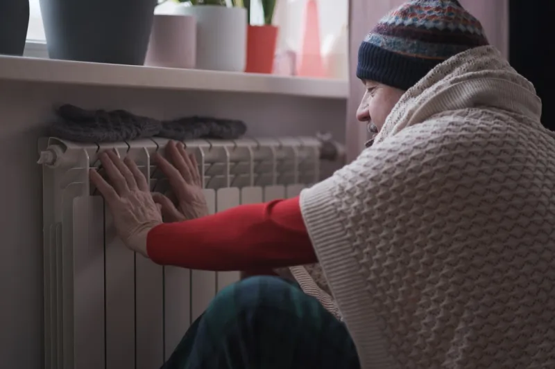 senior caucasian man feeling cold at home with home heating trouble