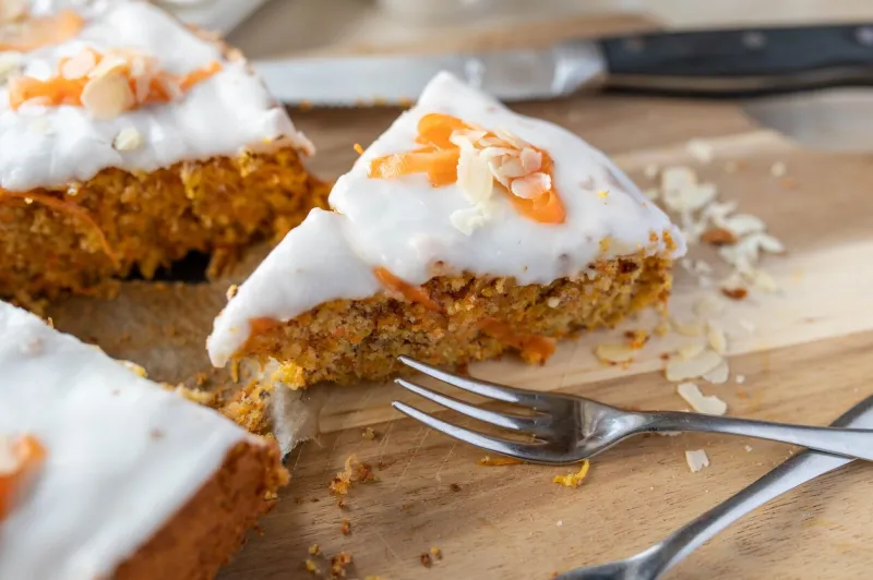 delicious slice of homemade carrot cake with almonds and sugar glaze for easter holiday