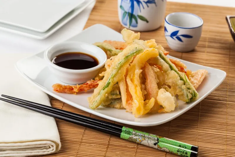 japanese tempura vegetables fried in a light batter served with soy sauce