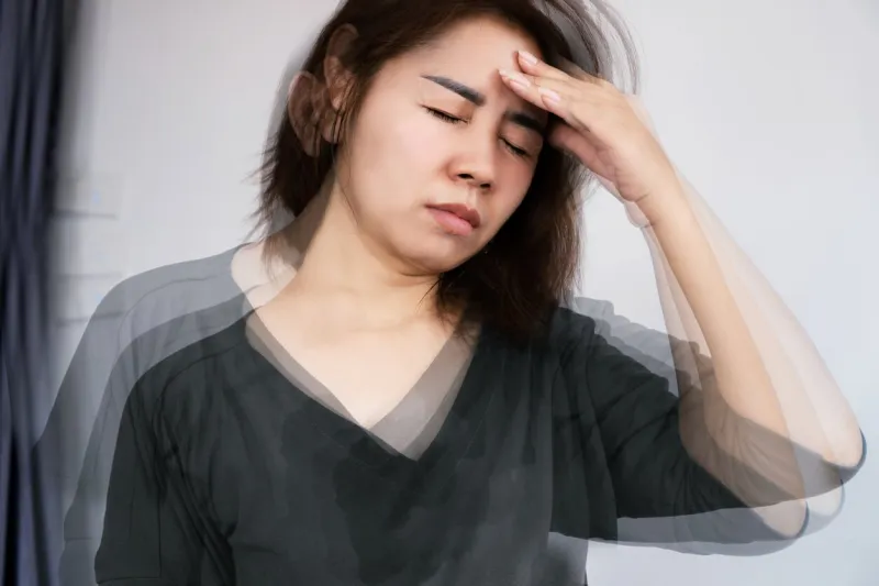 asian woman suffering from anemia feeling dizzy and vertigo , weakness and shortness of breath