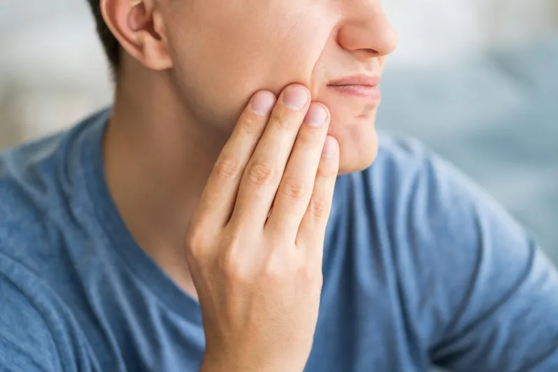 a man with toothache, periodontal disease in wisdom teeth, health problems concept