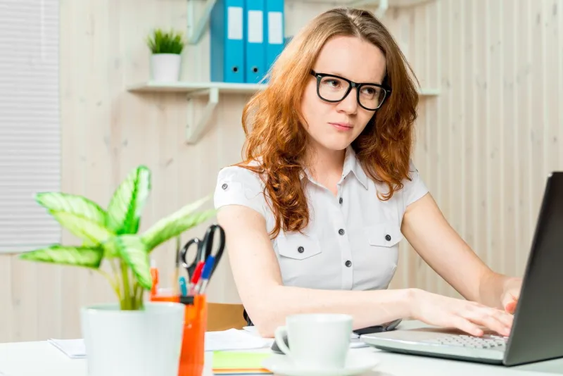 focused accountant with glasses working on a computer in the office