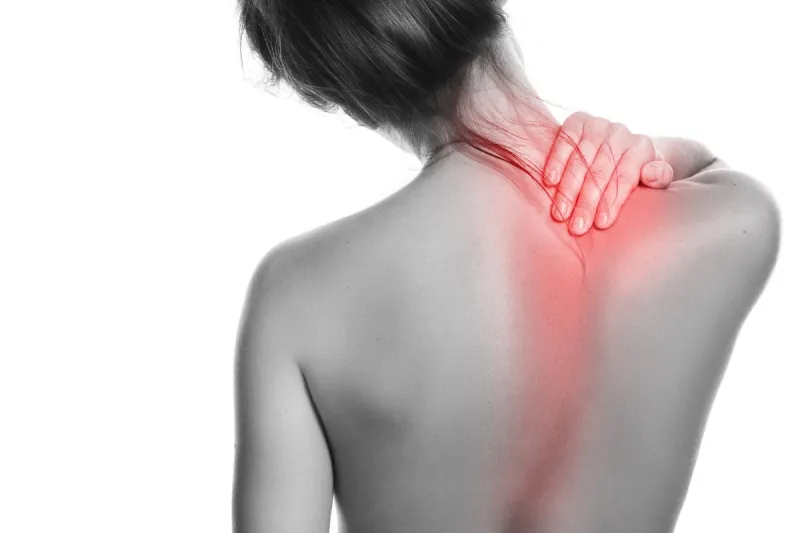 woman with pain in her back and neck on white background