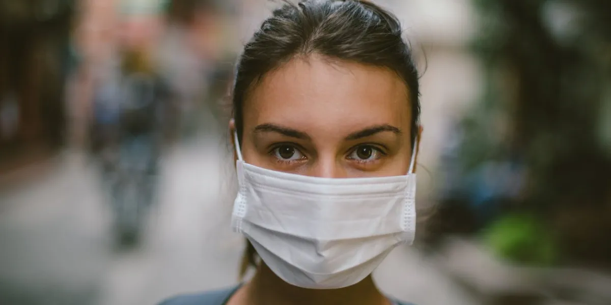 young woman wearing face mask in the street