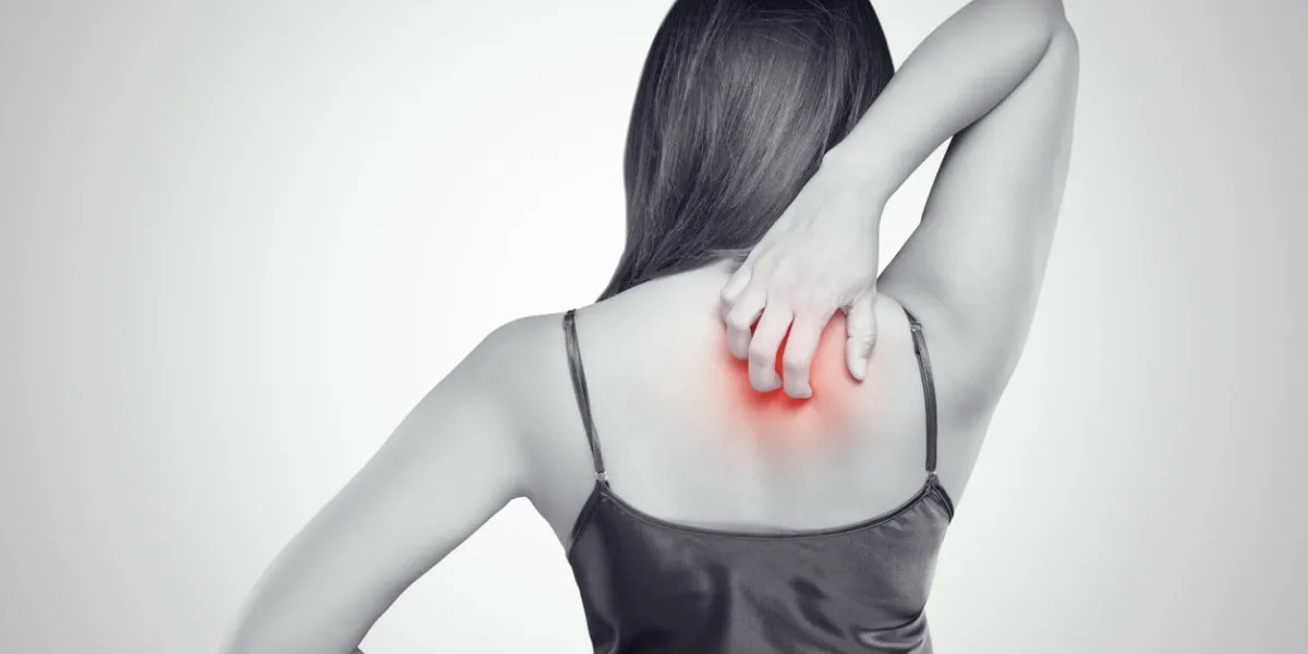 woman scratching her itchy back with allergy rash, concept with healthcare and medicine