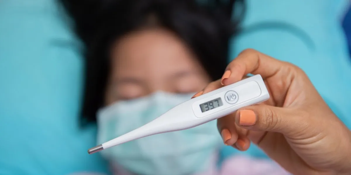 close-up mother hand holding thermometer taking child's temperature