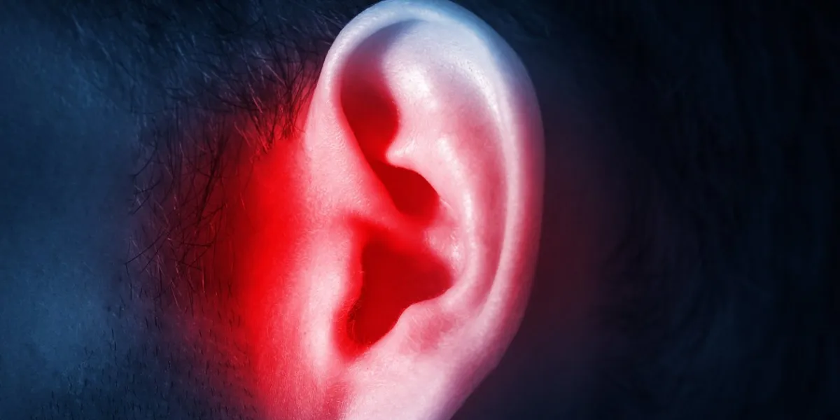 human male ear on a dark background isolated