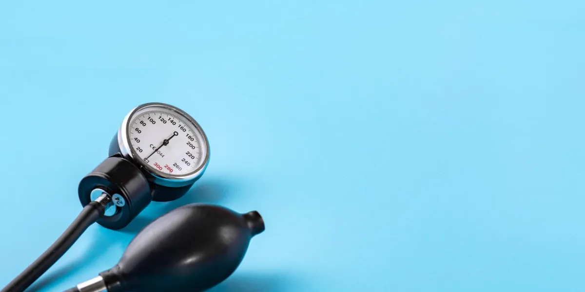 device for measuring blood pressure tonometer, cuff, stethoscope on a blue background copy-space