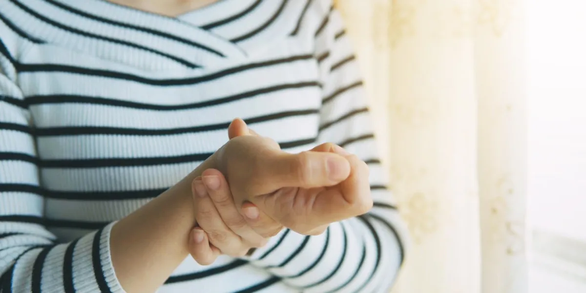 woman massaging her arthritic hand and wrist