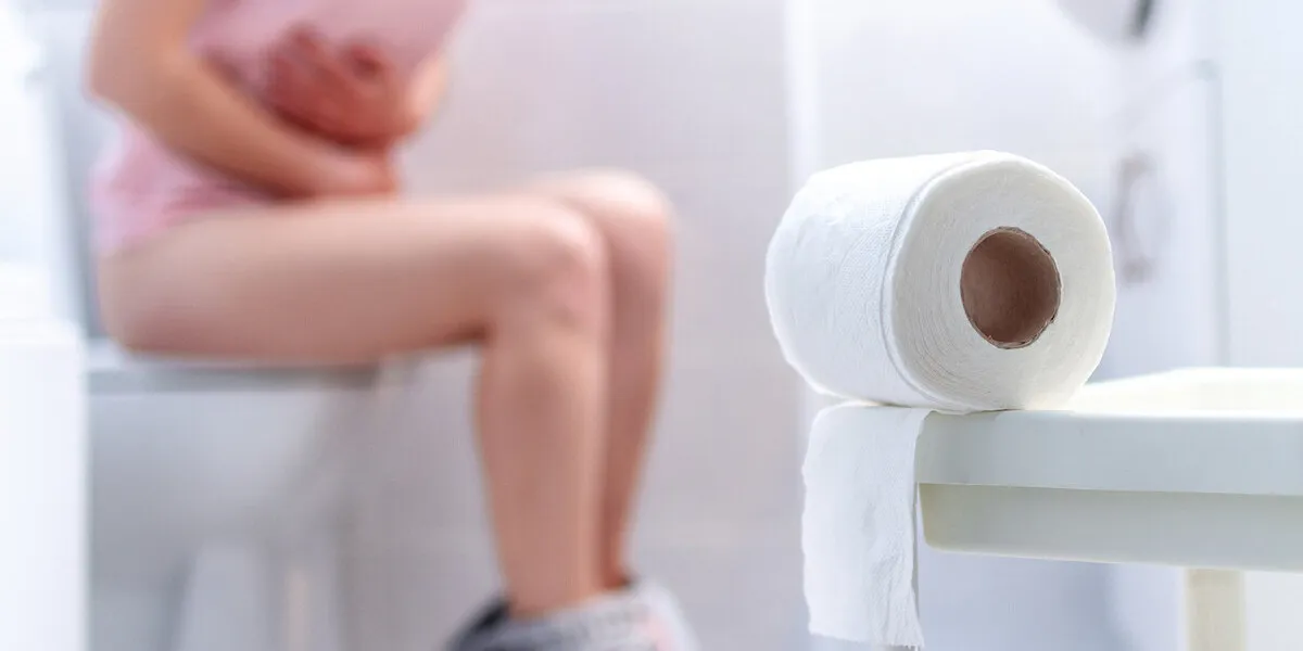 ill, unwell woman suffering from diarrhea, constipation and cystitis at toilet stomach pain during pms health care and pain concept