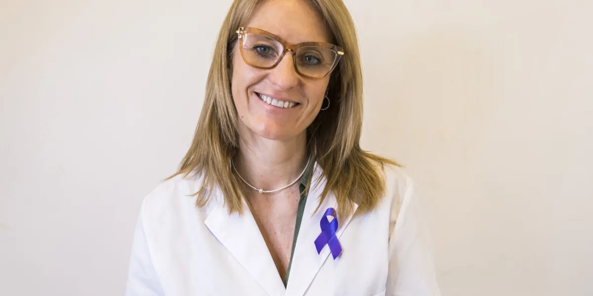 female doctor using cancer awareness ribbon