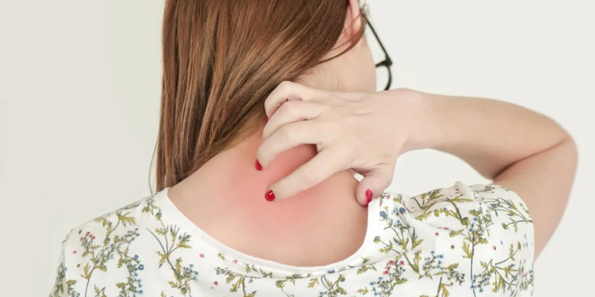 close up view of woman scratching her neck