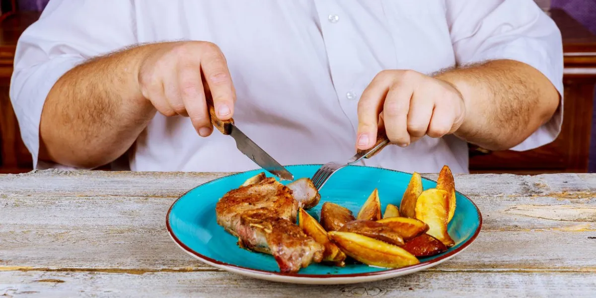 man nutritious lunch restaurant pork steaks with roasted potato