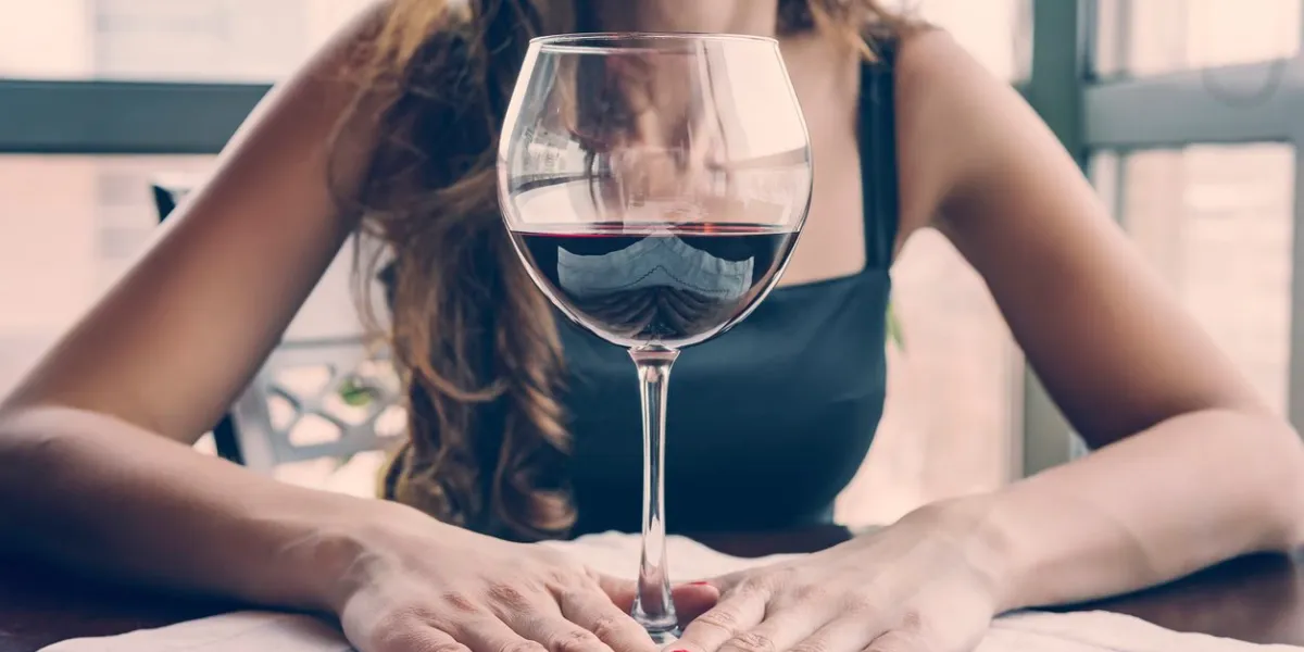 closeup portrait of young female customer drinking red wine with eyes closed woman drinking wine, taking a sip from a glass glass wine tasting in the restaurant