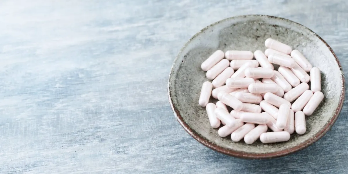 vitamin b12 supplement supports metabolism and nervous system health rustic wooden background close up