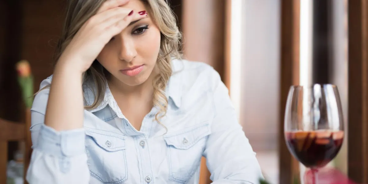 young woman deep thinking after she had some drink