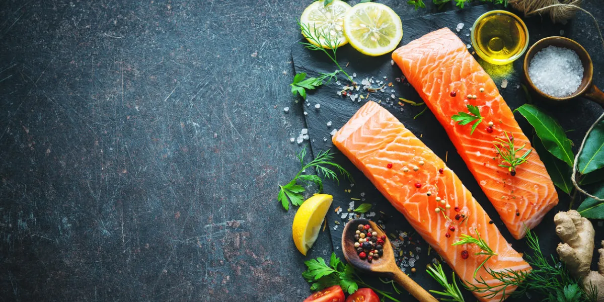 fresh salmon fillet with aromatic herbs, spices and vegetables balanced diet or cooking concept