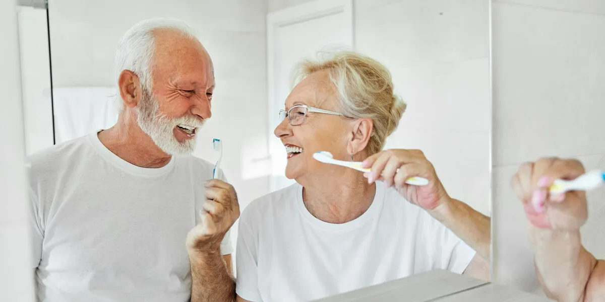 woman tooth bathroom toothbrush hygiene senior morning routine brushing toothpaste care dental elderly home retirement mouth mirror health cleaning man couple