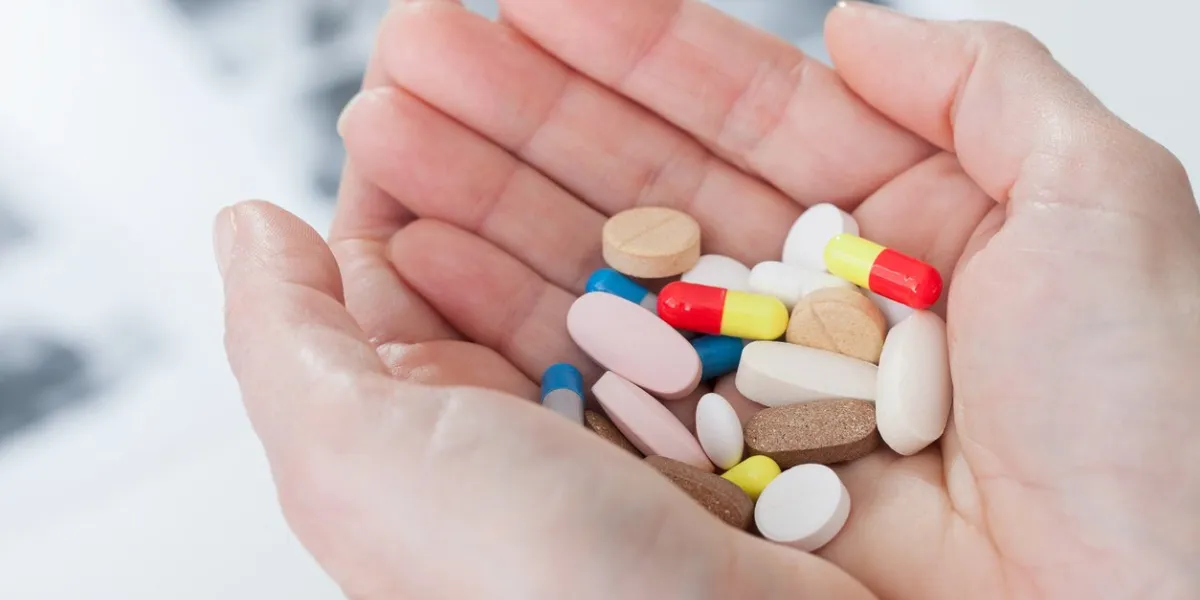 pills on female hands cloce up suicide concept