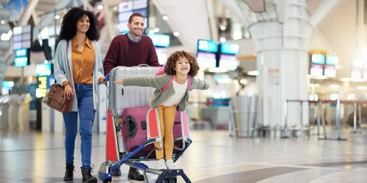 airport, family and child excited for flight with suitcase trolley on holiday, vacation or immigration journey and travel luggage of mother, father or diversity parents with girl kid flying in lobby