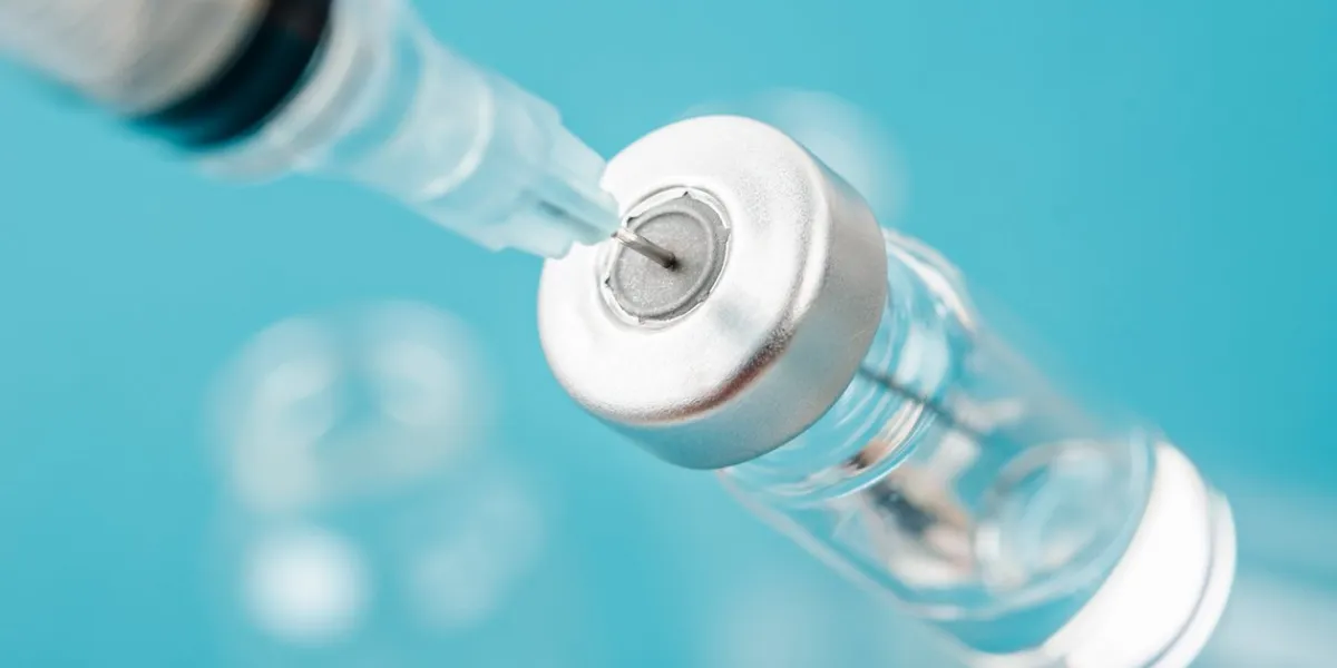 vaccine vial dose with needle syringe, medical concept vaccination in laboratory background