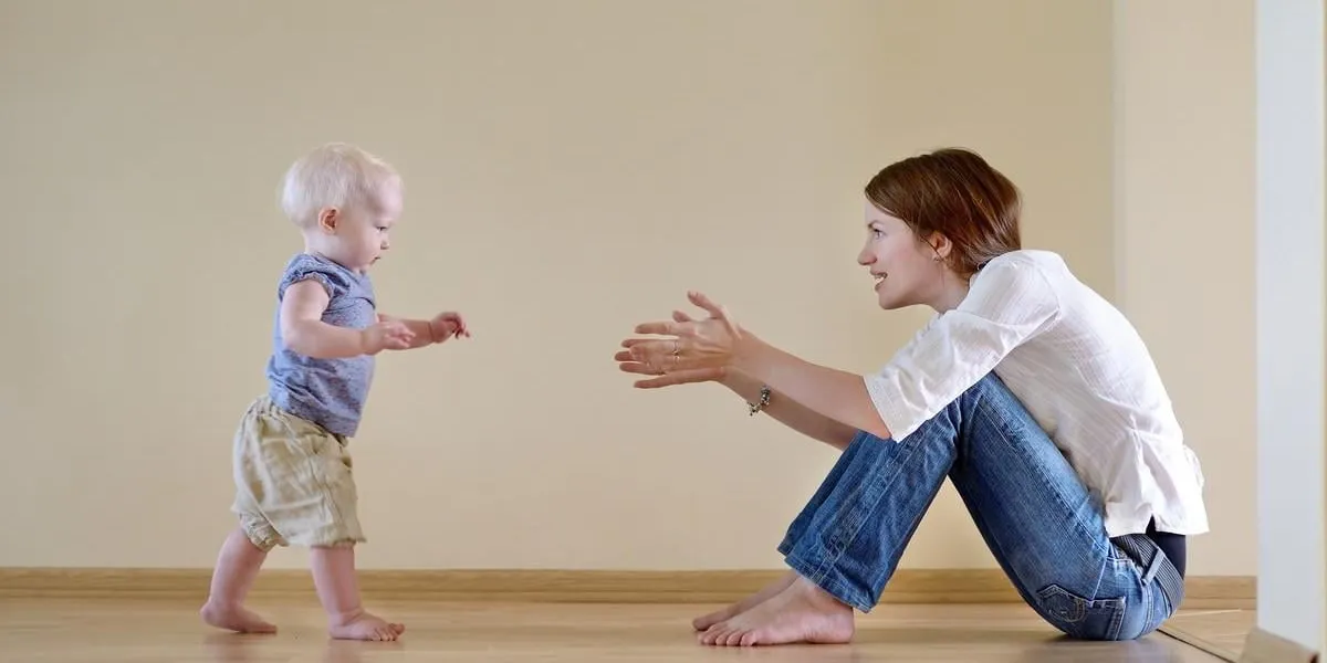 cute smiling baby girl learning to walk