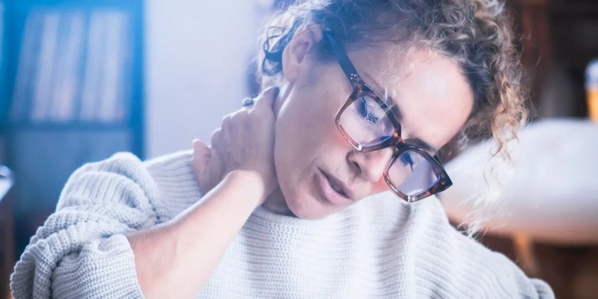 one adult woman touching massaging her neck for painful bad posture condition tired lady massaging rubbing stiff sore neck tensed muscles fatigued joint shoulder back pain ache fibromyalgia concept