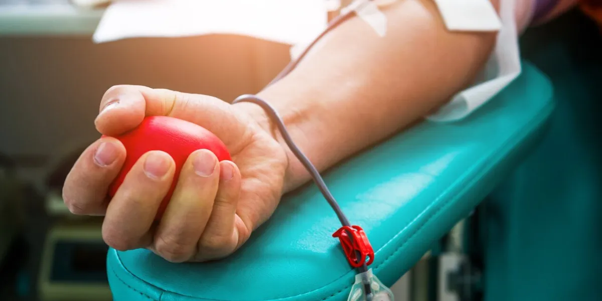 blood donor at donation with bouncy ball holding in hand