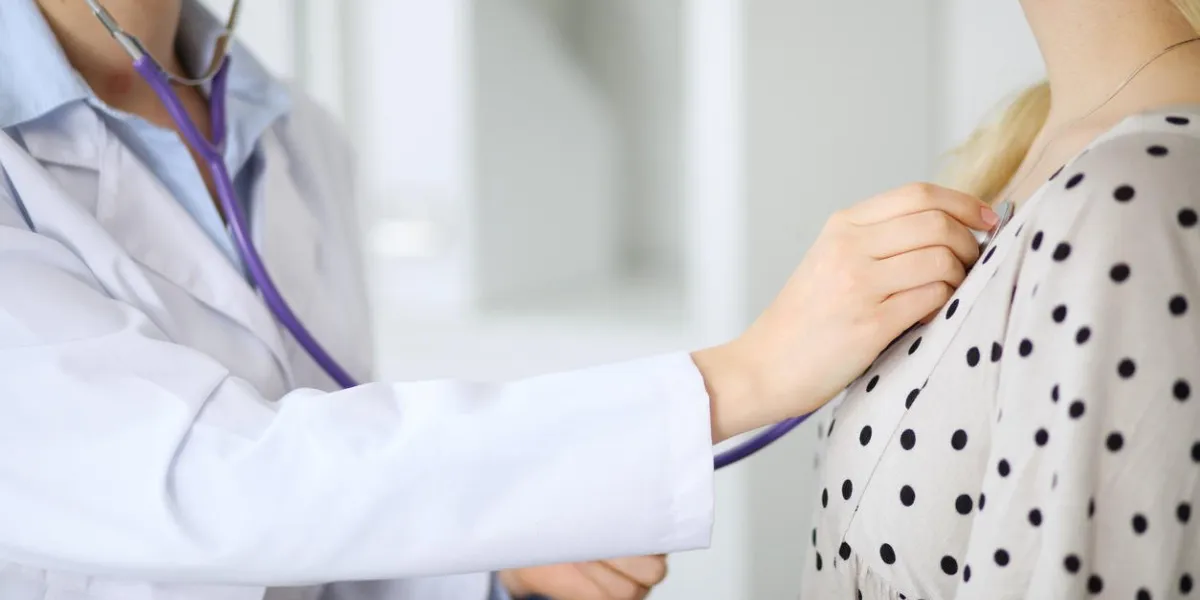 doctor examines a patient with a stethoscope