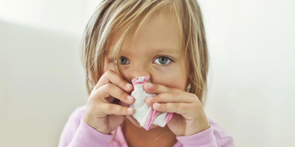 sick toddler girl with handkerchief at the home