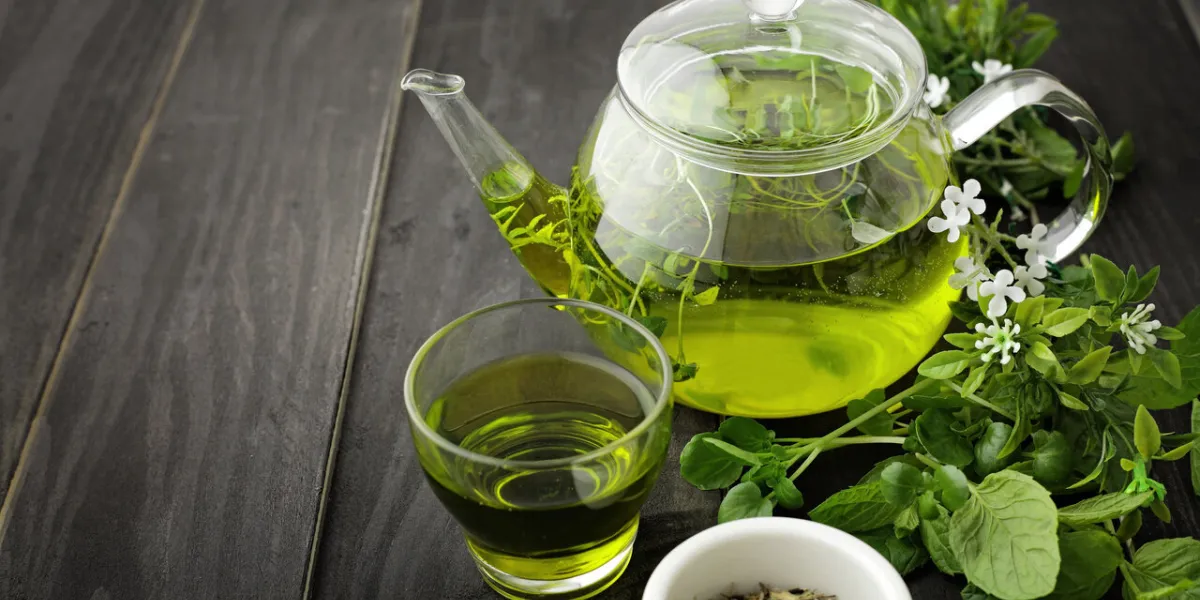 healthy green tea cup with tea leaves