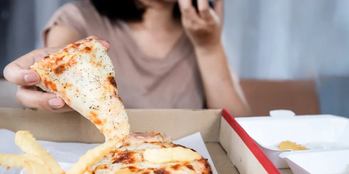 binge eating disorder concept with woman over eating fast food pizza