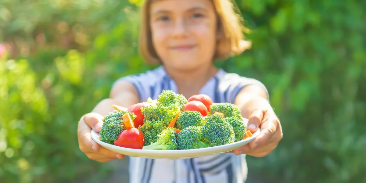 portrait of smiling woman holding salad